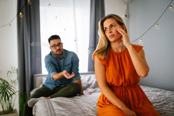 Sad Pensive Couple Thinking Of Relationships Problems Sitting On Sofa